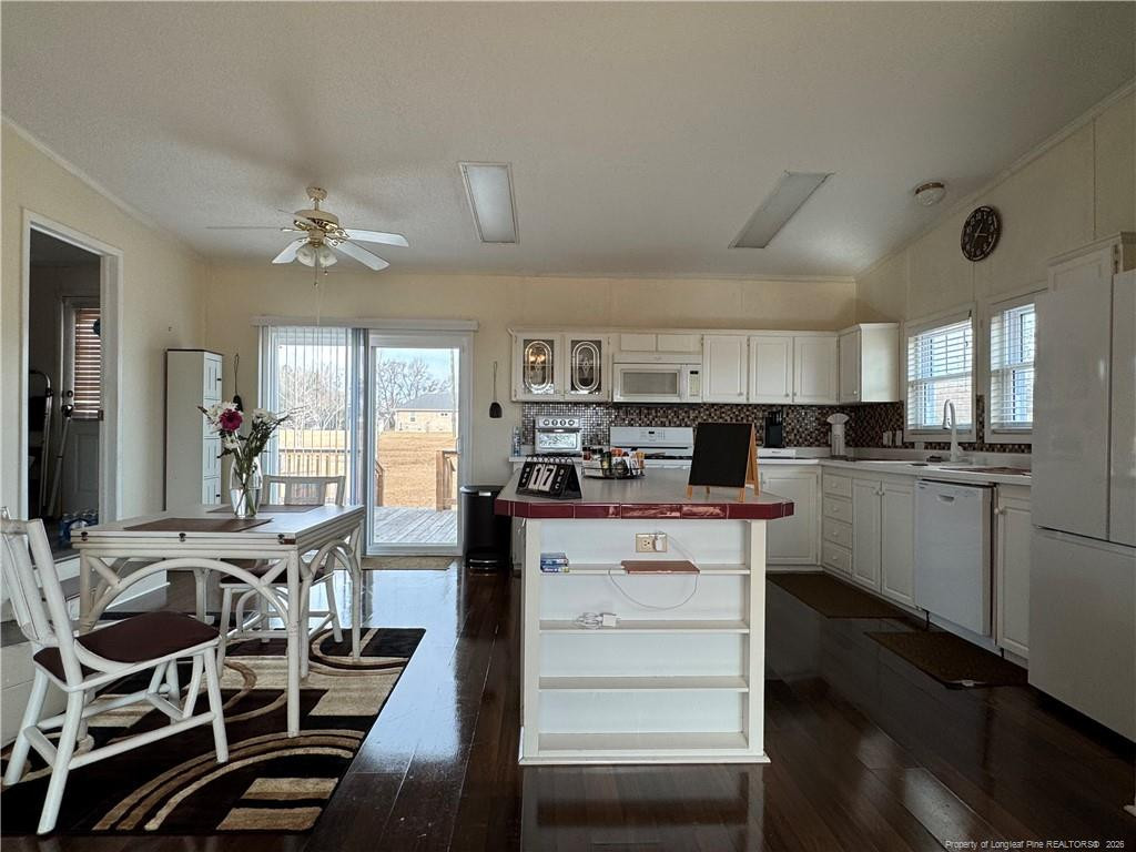 100 L Wallace McClean Road Raeford, NC 28376 - Photo 21 of 38 a kitchen with cabinets and chairs