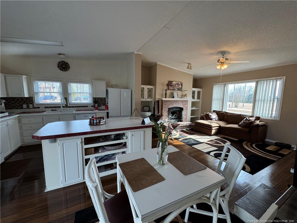 100 L Wallace McClean Road Raeford, NC 28376 - Photo 22 of 38 a view of a dining room with furniture a kitchen and chandelier