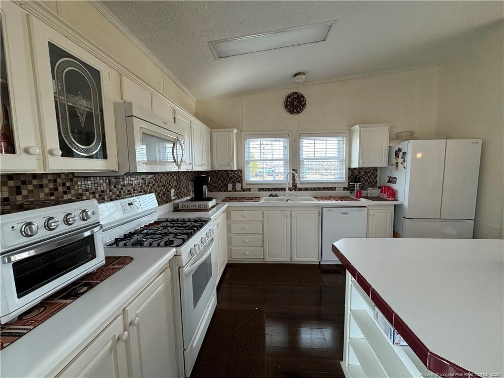100 L Wallace McClean Road Raeford, NC 28376 - Photo 24 of 38 a kitchen with a stove a sink and a microwave
