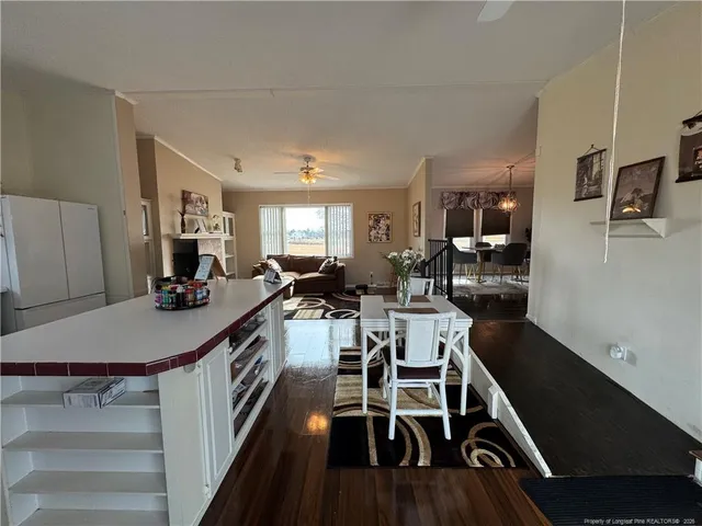 a kitchen with a dining table chairs and white cabinets