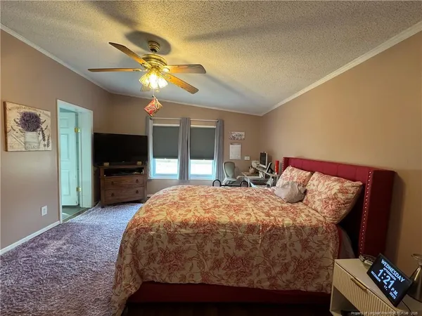 a bed room with a bed and a television