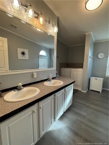 a bathroom with a double vanity sink and a mirror