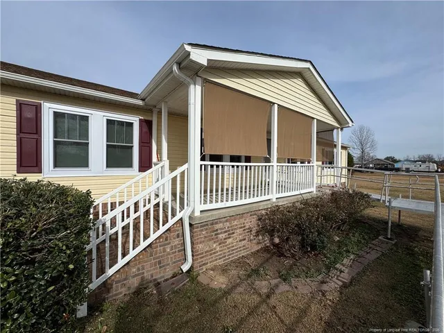 a view of a house with backyard and porch