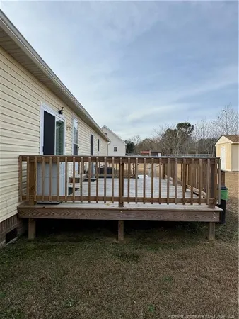 a view of a wooden house with a yard