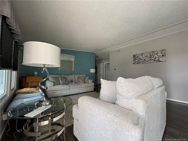 a living room with furniture and a lamp