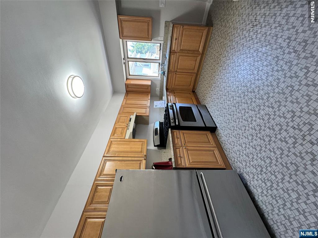 251 Fort Lee Road, Unit D Teaneck, NJ 07666 - Photo 5 of 14 a kitchen with stainless steel appliances a refrigerator sink and cabinets