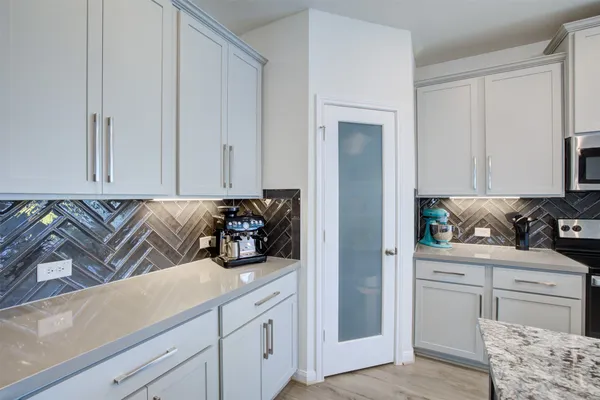 a kitchen with a sink and cabinets
