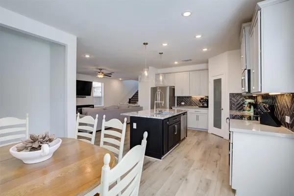 a kitchen with kitchen island granite countertop lots of counter top space and living room