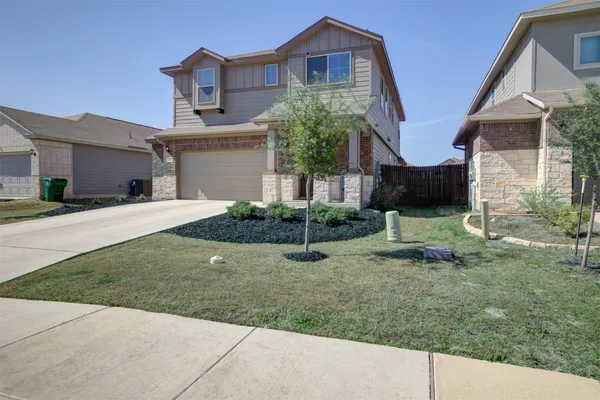 a view of a house with a yard and plants