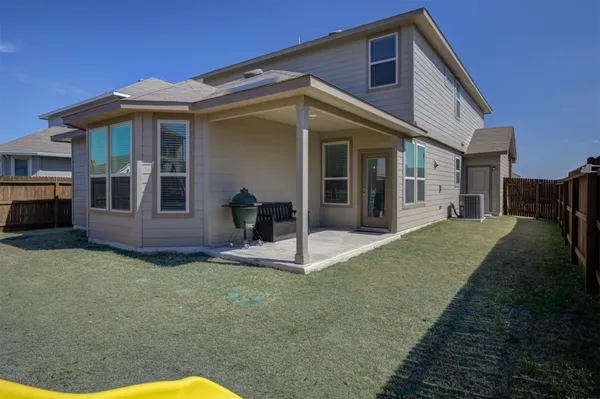 a view of a house with backyard and porch