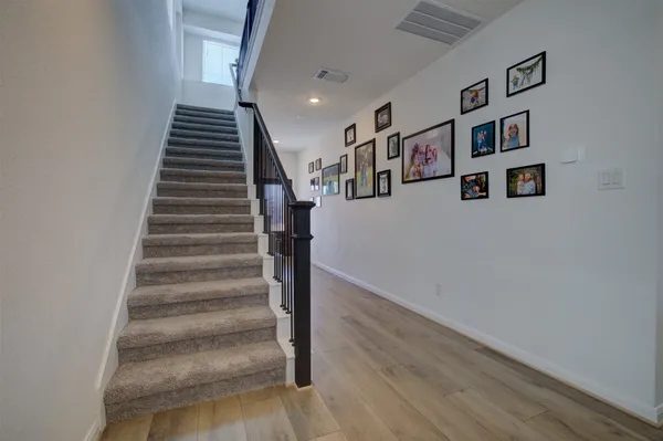 a view of entryway and hall with wooden floor