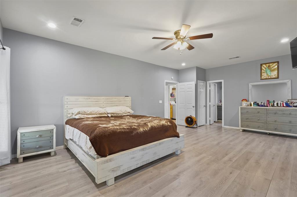 1556 John Wayne Road Kaufman, TX 75142 - Photo 10 of 33 a bedroom with a bed and a ceiling fan