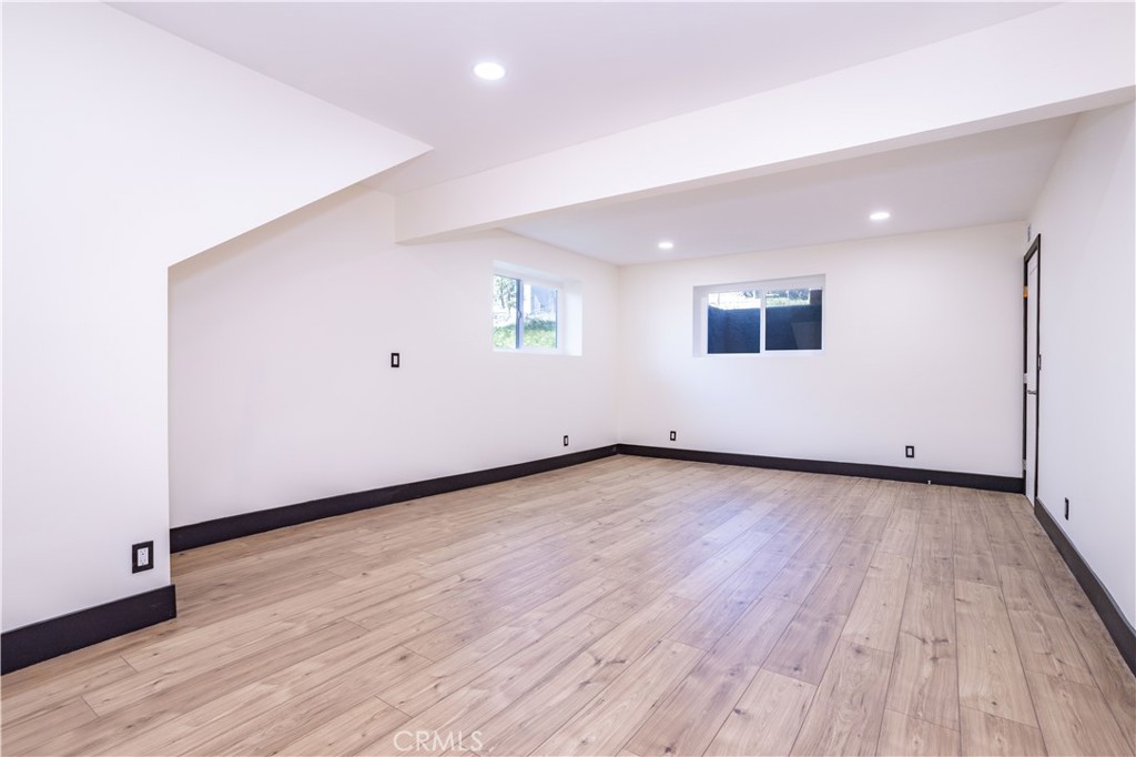 42640 Ranch Club Road Lake Hughes, CA 93532 - Photo 18 of 27 an empty room with wooden floor and windows