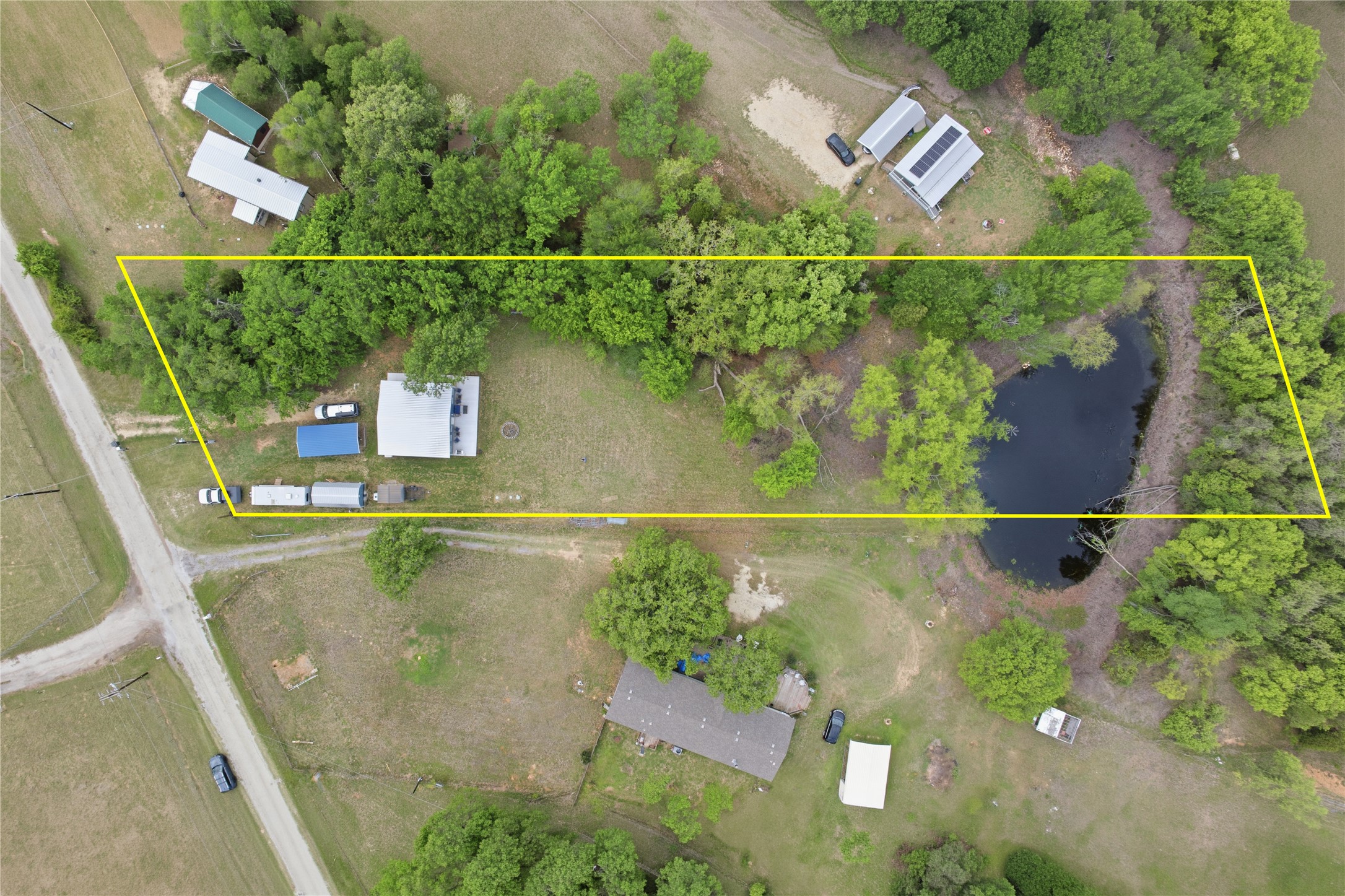 224 Old Coach Lane Elgin, TX 78621 - Photo 17 of 25 Aerial view of property's location with property parcel outlined and a large body of water