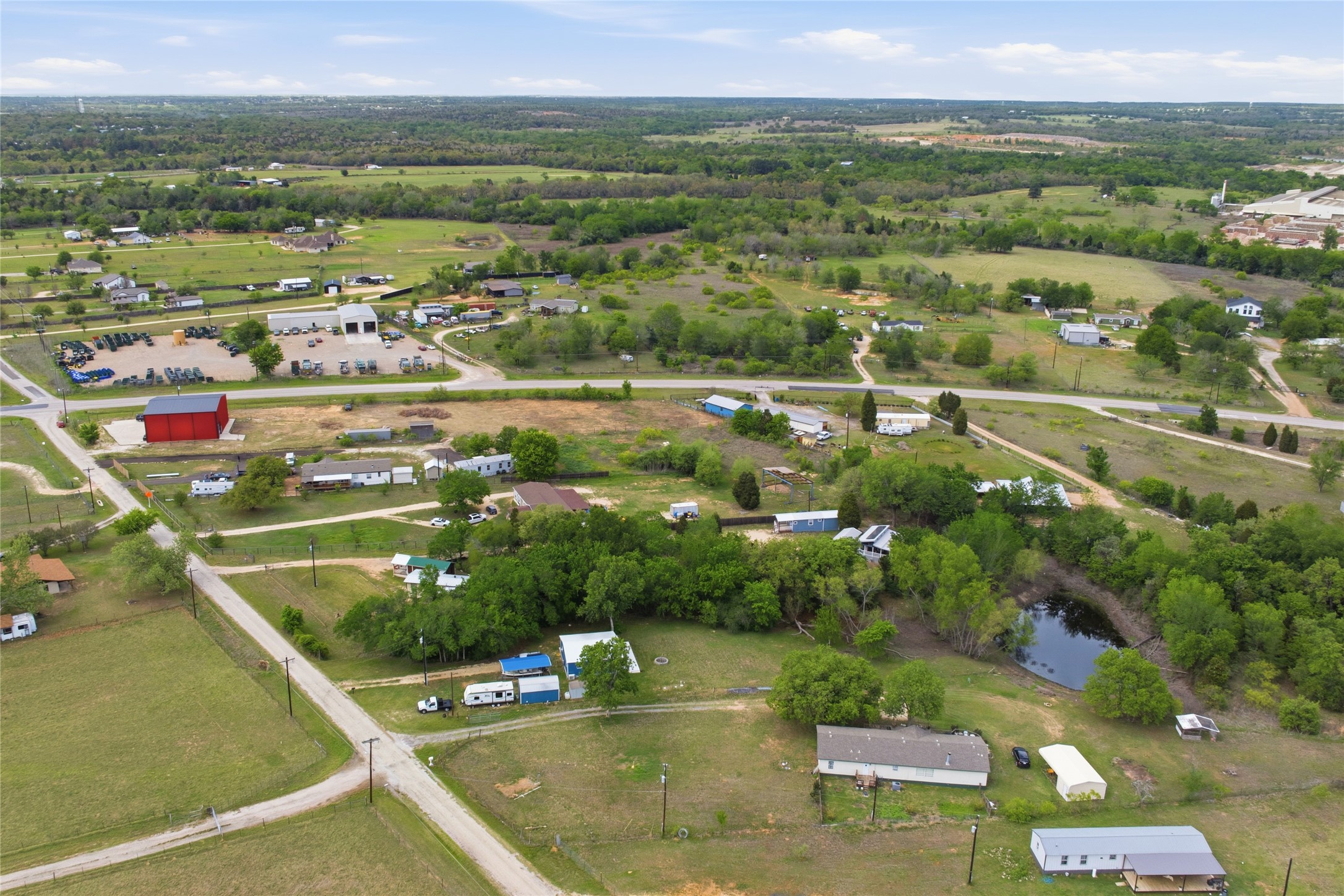224 Old Coach Lane Elgin, TX 78621 - Photo 22 of 25 Aerial view of property and surrounding area featuring a nearby body of water
