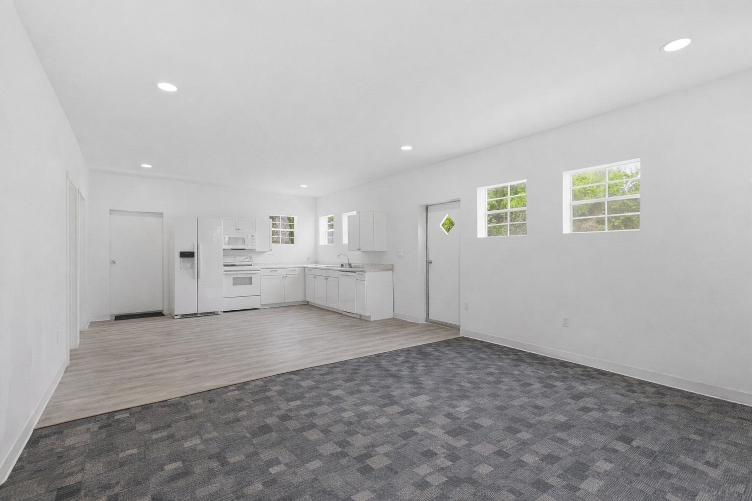 224 Old Coach Lane Elgin, TX 78621 - Photo 7 of 25 Spacious open-concept living area with clean white walls and recessed lighting