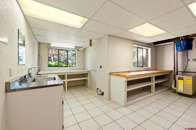 a view of kitchen with sink and window