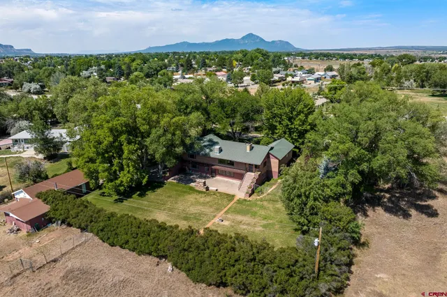 an aerial view of a house with a yard