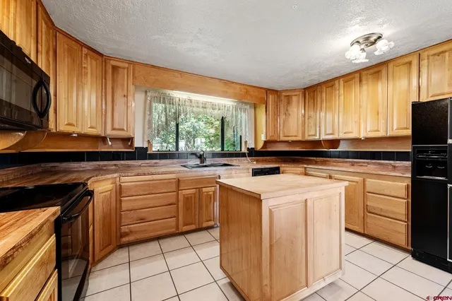 a kitchen with a stove a sink and a microwave