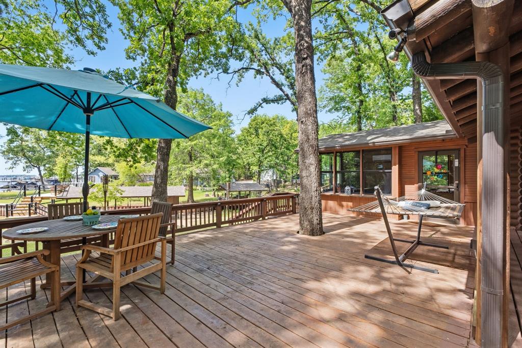 114 Trails End Mabank, TX 75156 - Photo 12 of 40 a view of a table and chairs under an umbrella