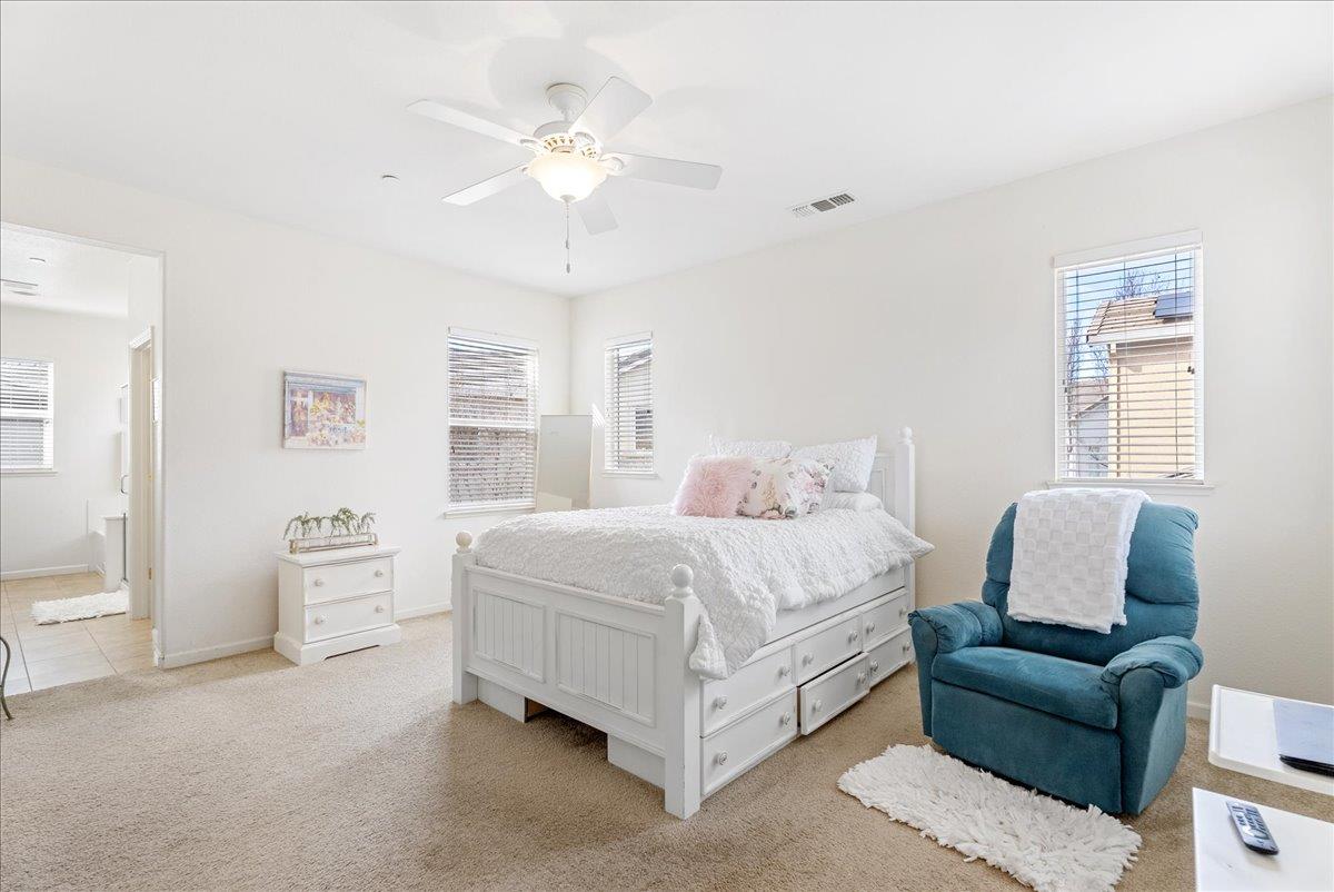 719 Courtyards Loop Lincoln, CA 95648 - Photo 18 of 33 a spacious bedroom with a bed and a couch