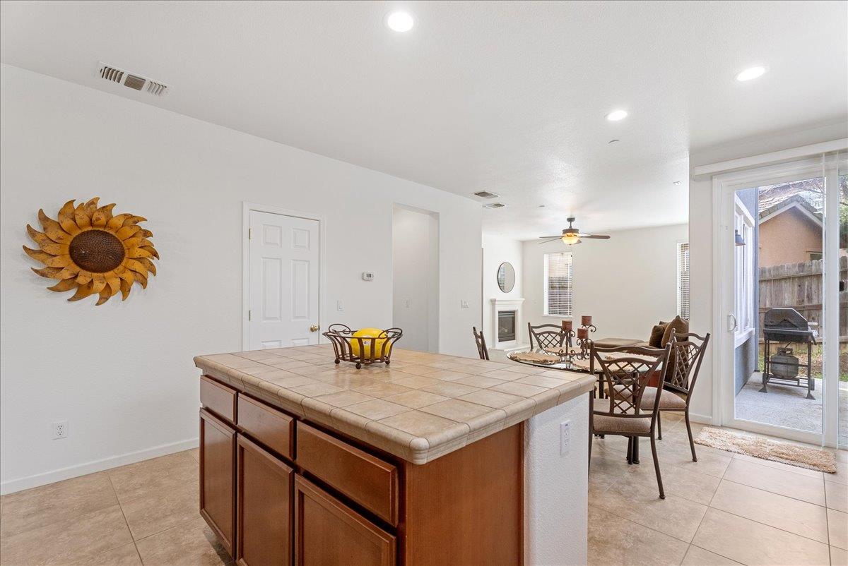 719 Courtyards Loop Lincoln, CA 95648 - Photo 9 of 33 a kitchen with a table and chairs in it