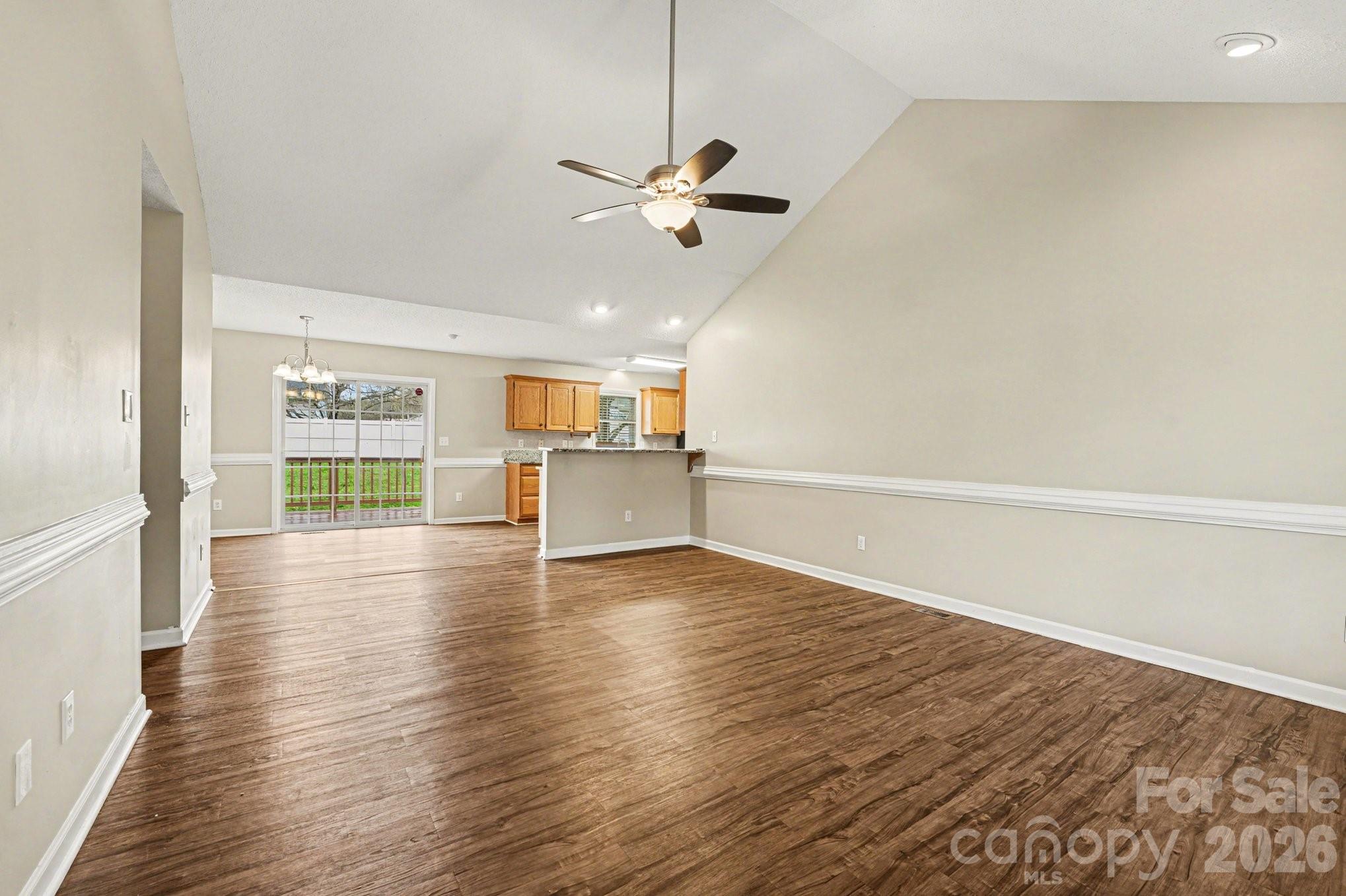 134 Clearview Road Statesville, NC 28625 - Photo 3 of 16 a view of a room with wooden floor a ceiling fan and windows