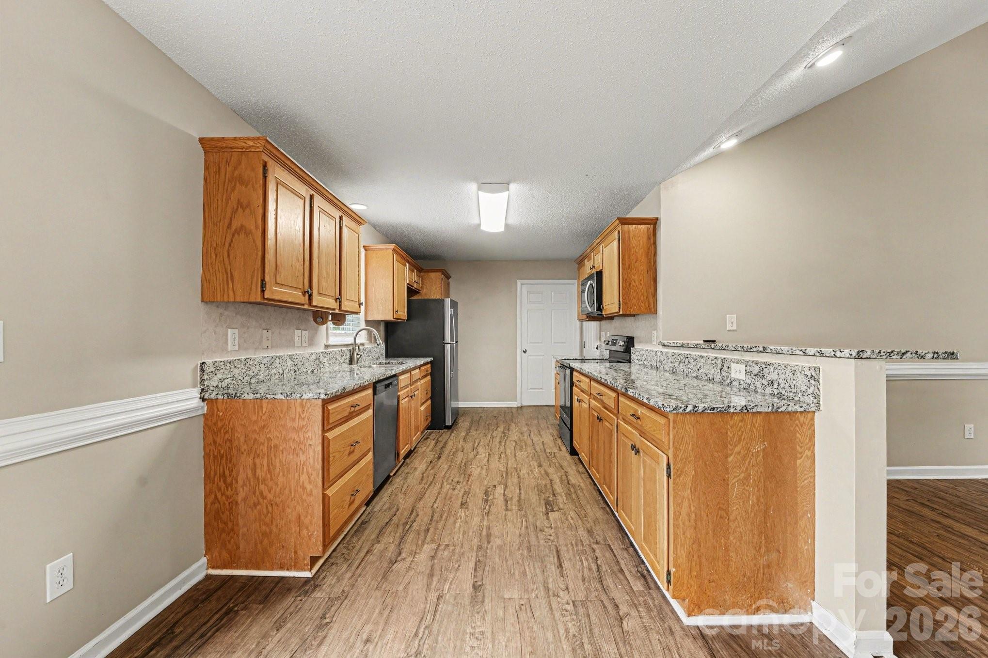 134 Clearview Road Statesville, NC 28625 - Photo 4 of 16 a large kitchen with granite countertop a sink and cabinets