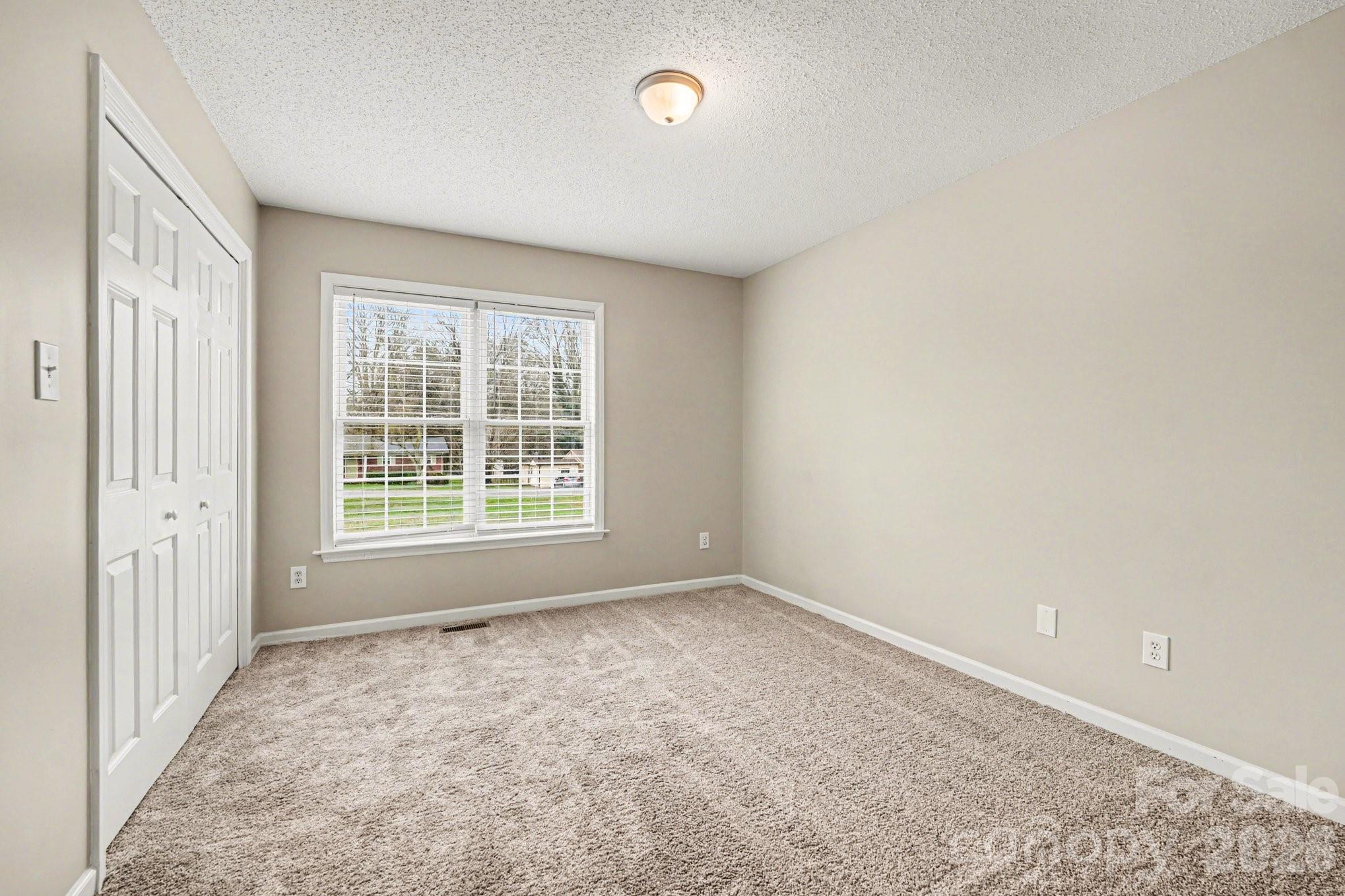 134 Clearview Road Statesville, NC 28625 - Photo 10 of 16 an empty room with a empty space and a window