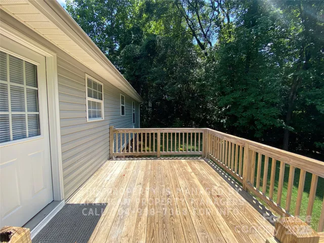 a view of balcony with wooden floor and fence