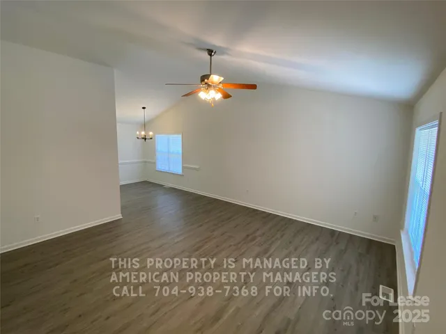 a view of a room with wooden floor and windows