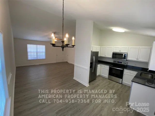 a kitchen with granite countertop a stove and a refrigerator