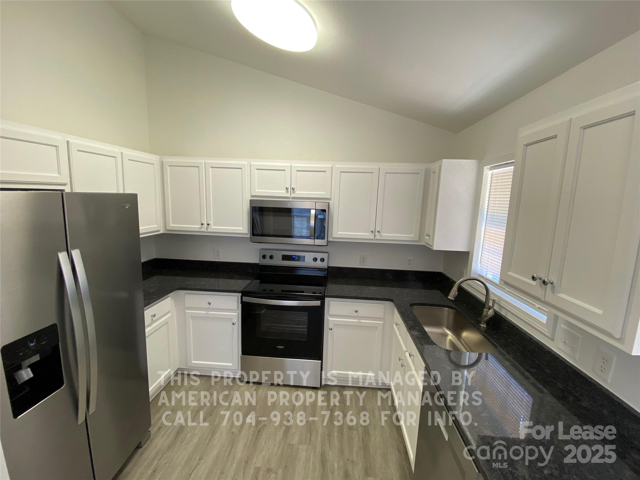 41 Ridge Court Southeast Concord, NC 28025 - Photo 5 of 14 a kitchen with granite countertop a refrigerator stove and sink