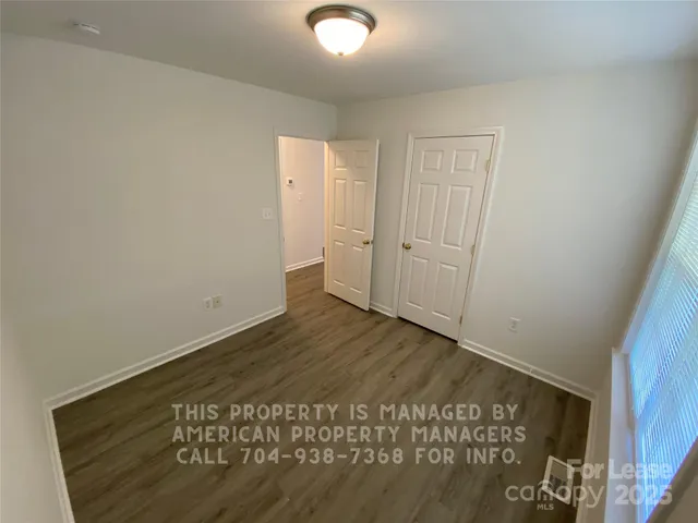 a view of a room with wooden floor and closet