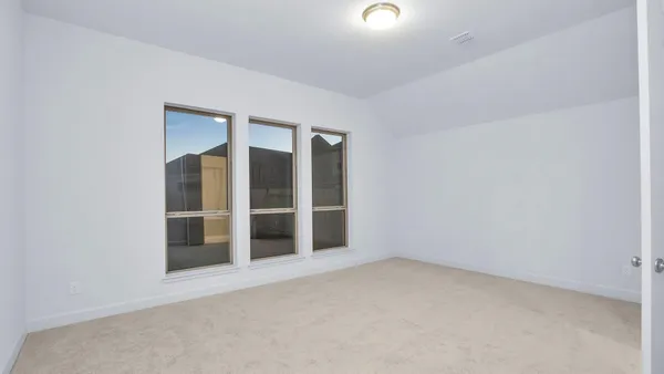 an empty room with closet and entryway