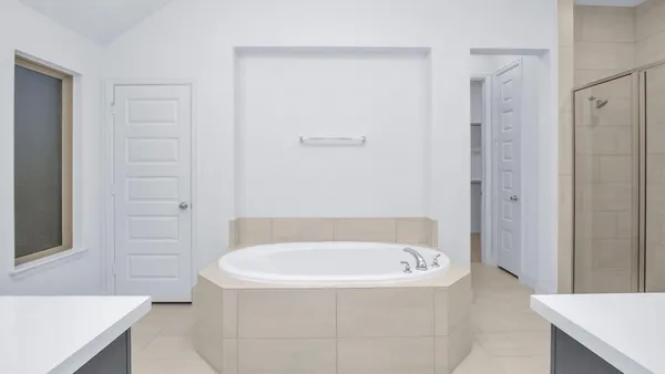 a bathroom with a bathtub and a shower