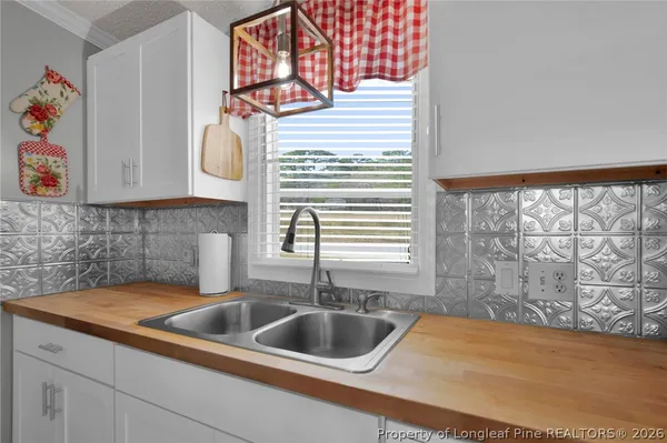a kitchen with a sink cabinets and a window