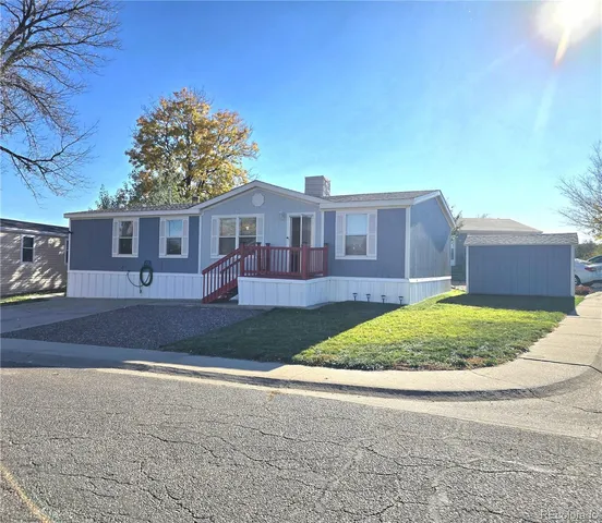 a view of a house with a backyard and a garden
