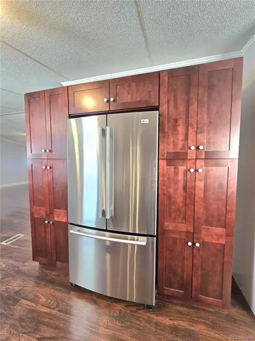 a view of water heater room with wooden floor