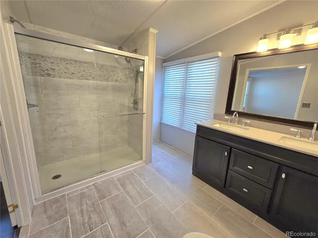 a bathroom with a shower sink and mirror