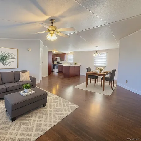 a living room with furniture and wooden floor