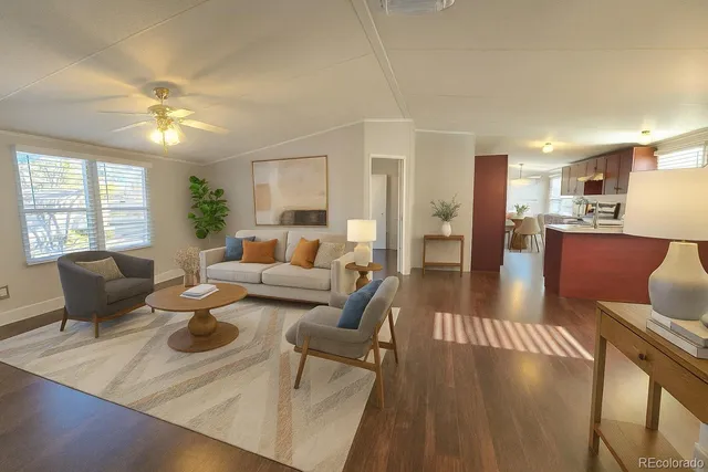 a living room with furniture and wooden floor