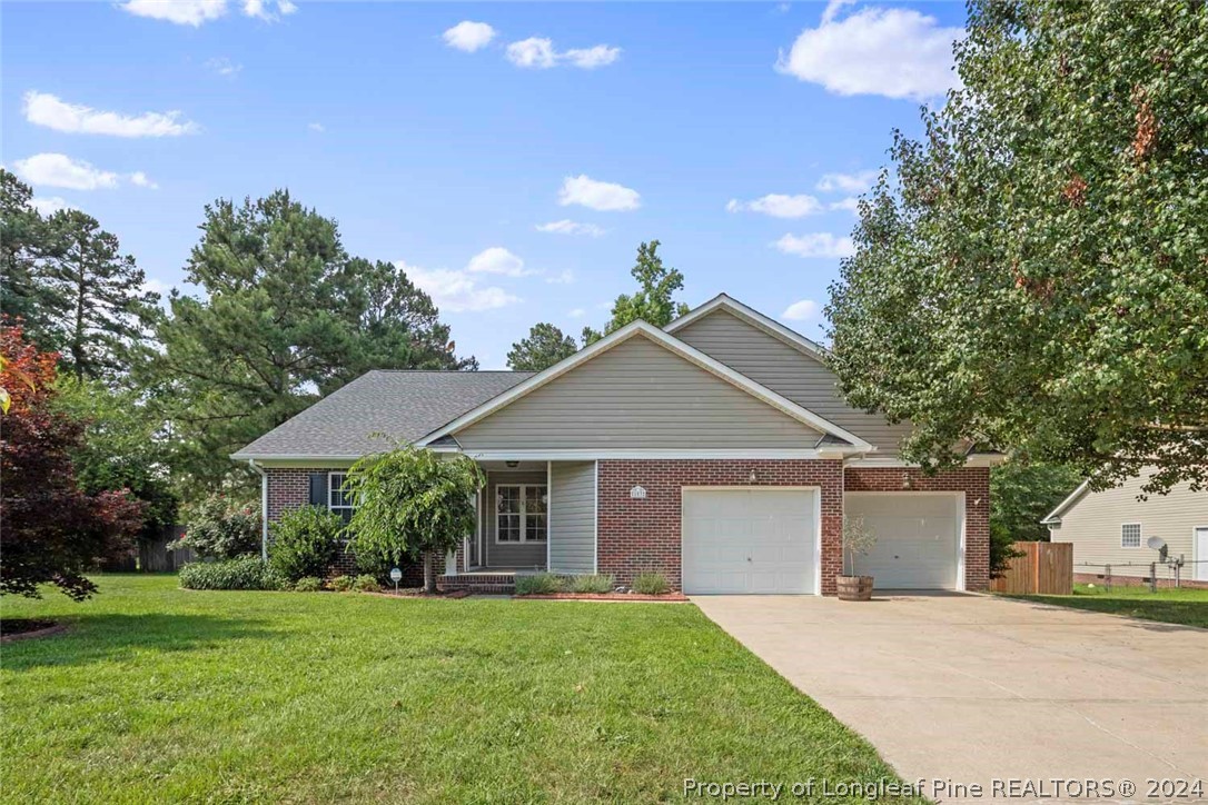 103 Kernstown Road Raeford, NC 28376 - Photo 1 of 48 a front view of a house with a garden and yard
