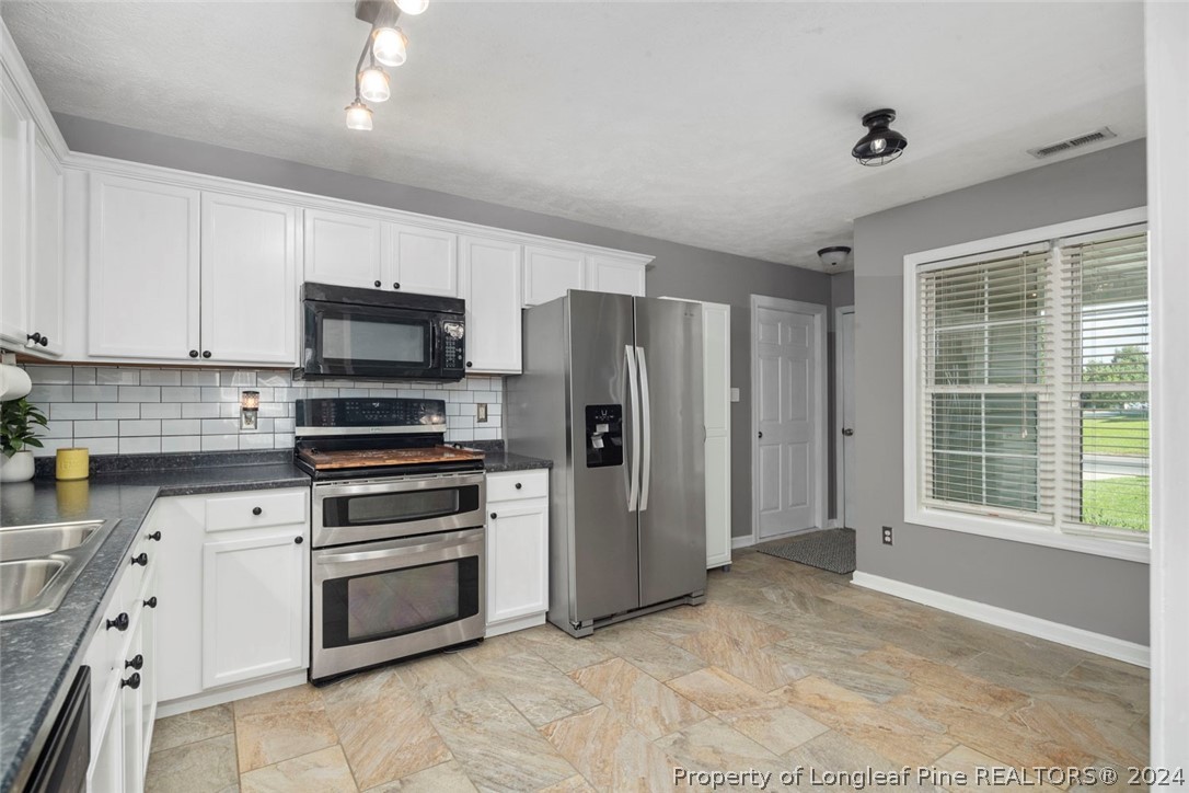 103 Kernstown Road Raeford, NC 28376 - Photo 13 of 48 a kitchen with stainless steel appliances a refrigerator sink and microwave