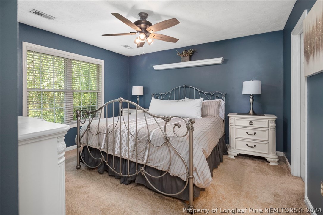 103 Kernstown Road Raeford, NC 28376 - Photo 21 of 48 a bedroom with a bed and a chandelier