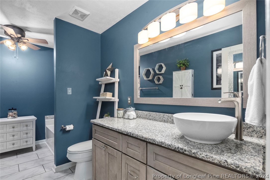 103 Kernstown Road Raeford, NC 28376 - Photo 23 of 48 a spacious bathroom with a granite countertop toilet sink and mirror