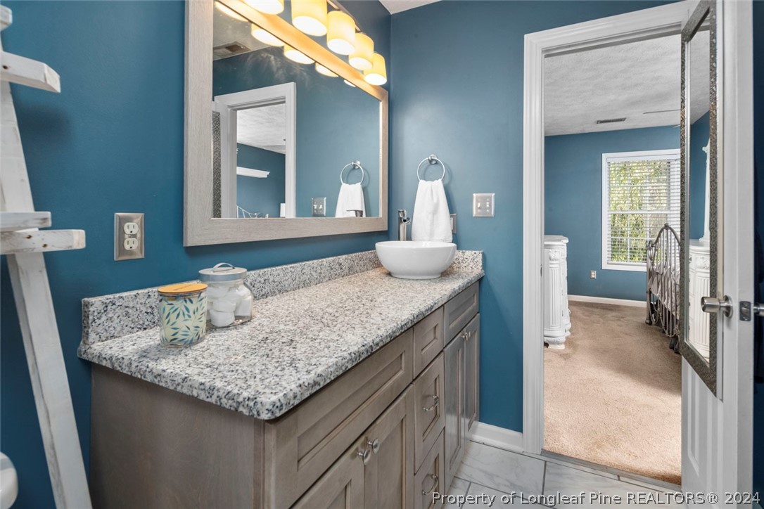103 Kernstown Road Raeford, NC 28376 - Photo 27 of 48 a bathroom with a granite countertop sink and a mirror