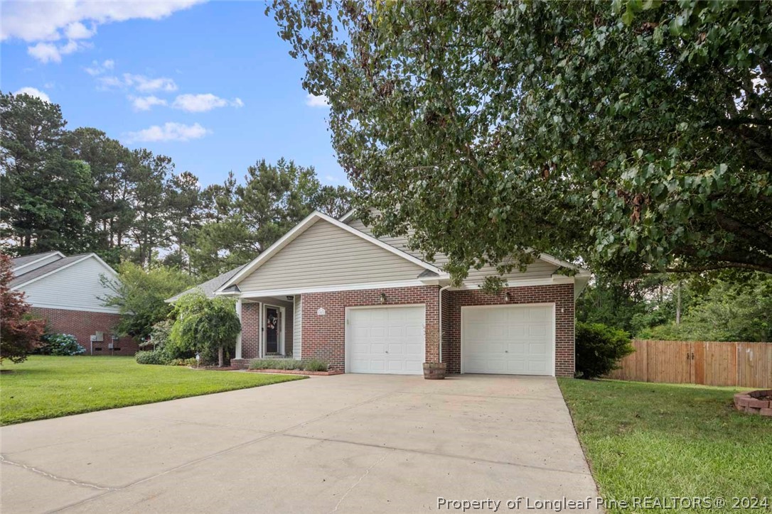 103 Kernstown Road Raeford, NC 28376 - Photo 3 of 48 a front view of a house with a yard and garage