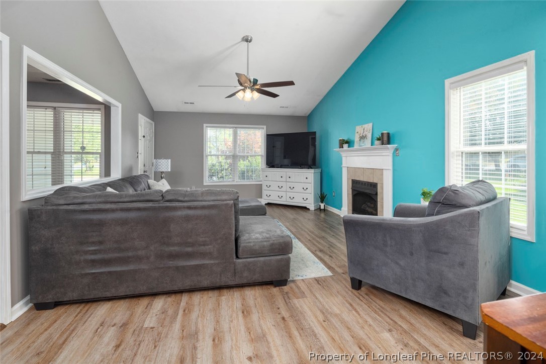 103 Kernstown Road Raeford, NC 28376 - Photo 10 of 48 a living room with furniture a fireplace and a flat screen tv