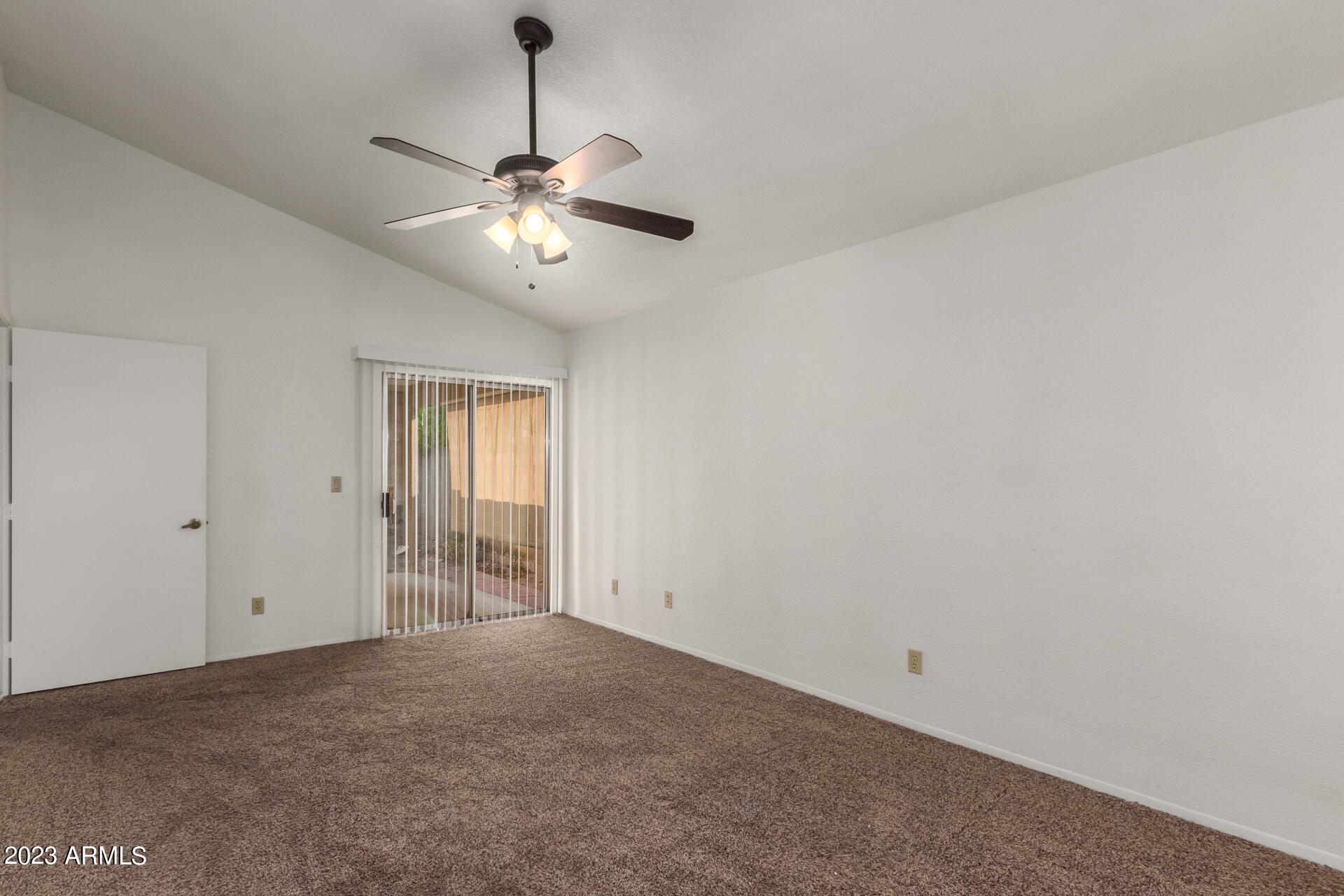 7331 West Paradise Drive Peoria, AZ 85345 - Photo 15 of 27 a view of an empty room and chandelier fan